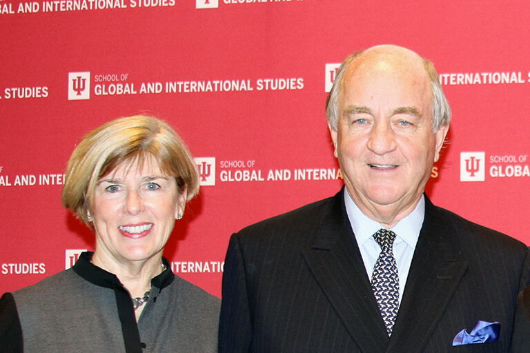 Deborah and Ambassador Randall Tobias posing for the camera at HLS.