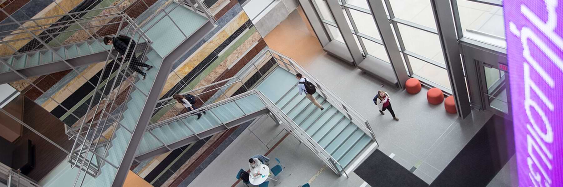 Students walking in the HLS atrium.