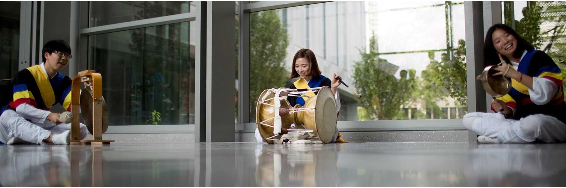 Performers playing instruments in the HLS atrium.