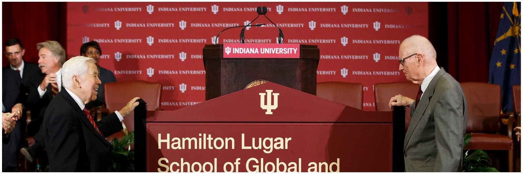 Former US Rep. Hamilton and former US Sen. Lugar are standing beside the sign for the school naming ceremony for the Lee H. Hamilton and Richard G. Lugar School of Global and International Studies.