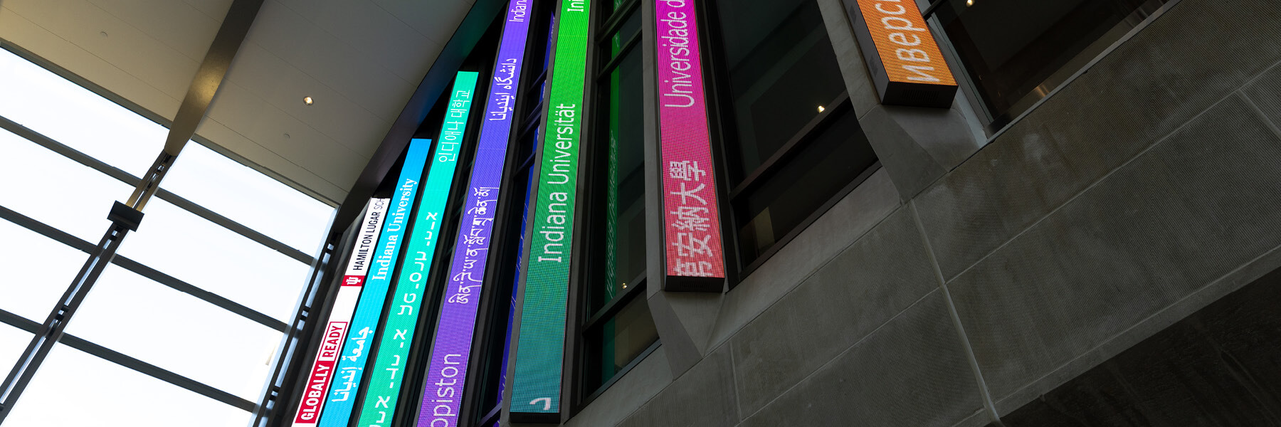 The digital blades in the HLS atrium display phrases in foreign languages.